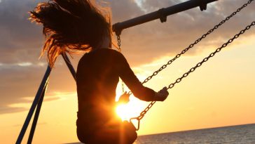 Top Stories of Woman riding on Golden hour swing