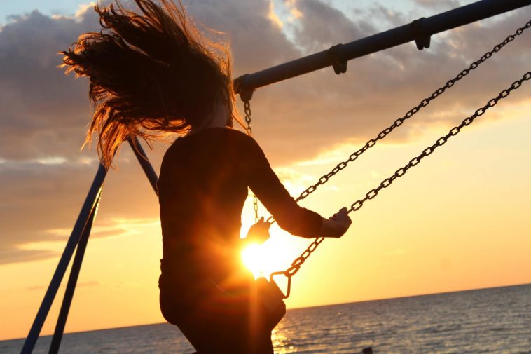Top Stories of Woman riding on Golden hour swing
